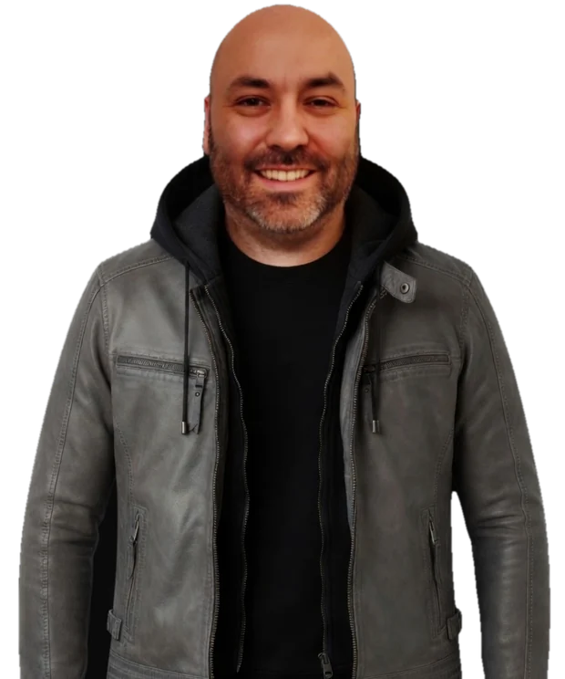 Neil Sisson, smiling, in a grey leather jacket